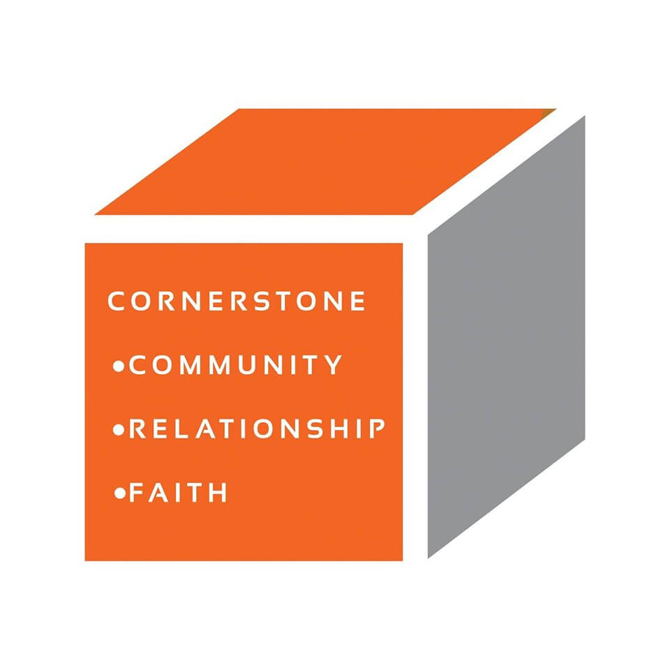 Cornerstone Baptist Logo; shows a cube with two orange sides and one grey side. On the front of the cube, there is white text that reads "Cornerstone: Community, relationship, faith"
